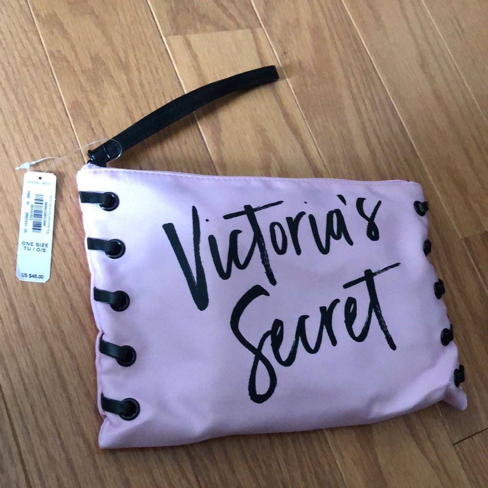Light pink wristlet with drawstring bag inside. Great for travel.